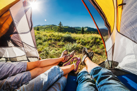 camping packing list legs in tent sunshine greenery